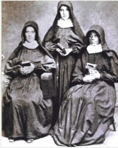 Adele is standing behind her first 2 postulants, and all are dressed in Franciscan habits.